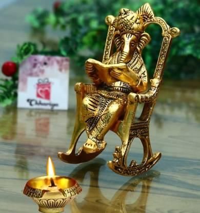 Golden Ganesha Showpiece – Lord Ganesha on Rocking Chair Reading Ramayan